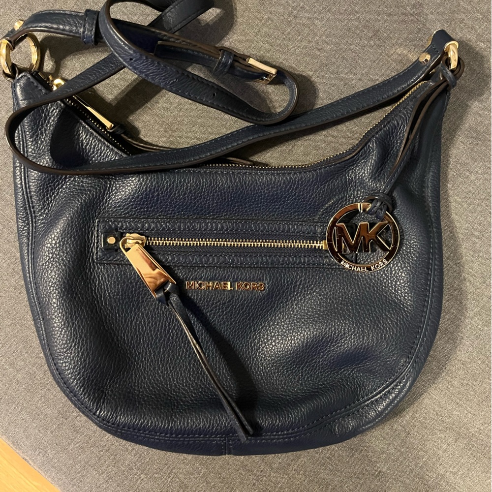 Good used condition navy blue Michael Kors cross body. No rips, tears, stains.